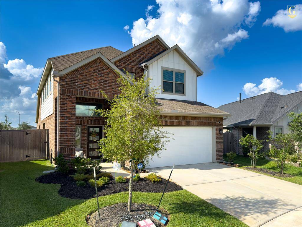 Front elevation with Knights Armor trim and Ghost Writer accents on a full brick façade. Built by Chesmar Homes with a two-car garage and located on a quiet cul-de-sac in Dellrose.
