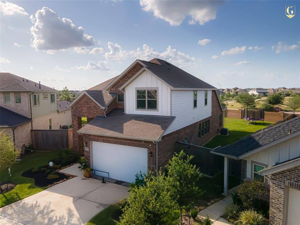 Front elevation with Knights Armor trim and Ghost Writer accents on a full brick façade. Built by Chesmar Homes with a two-car garage and located on a quiet cul-de-sac in Dellrose.