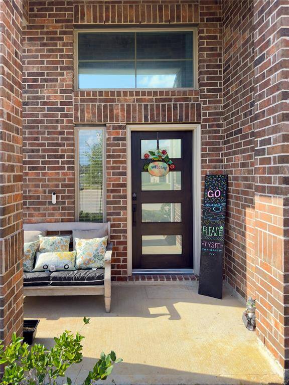 Front elevation with Knights Armor trim and Ghost Writer accents on a full brick façade. Built by Chesmar Homes with a two-car garage and located on a quiet cul-de-sac in Dellrose.