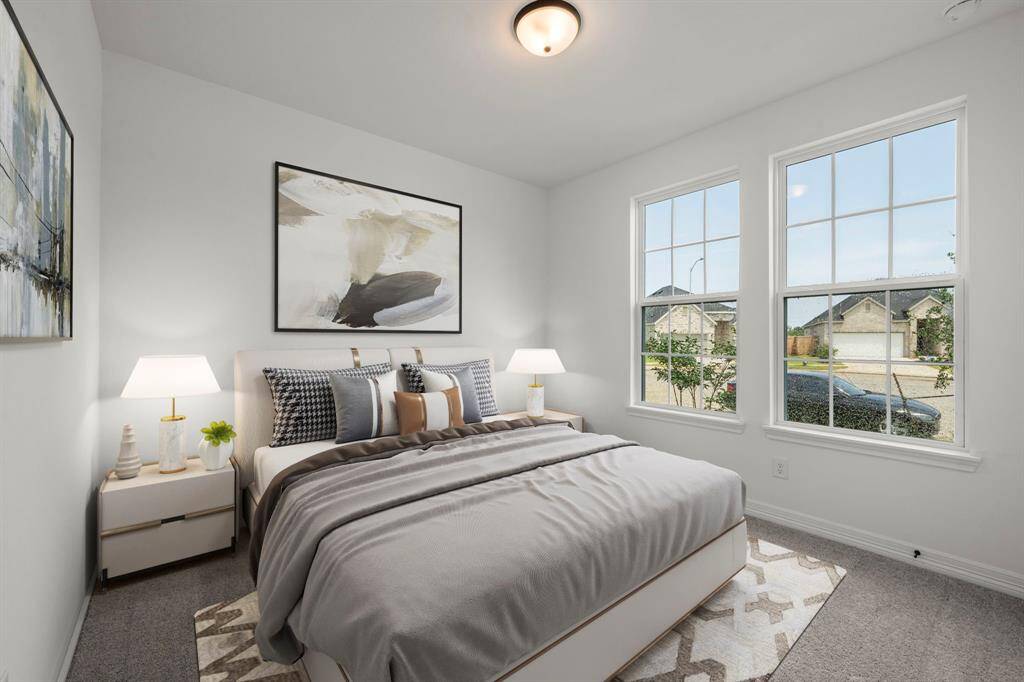 Your secondary bedroom features plush carpet, fresh paint, closet, and a large window that lets in plenty of natural lighting.