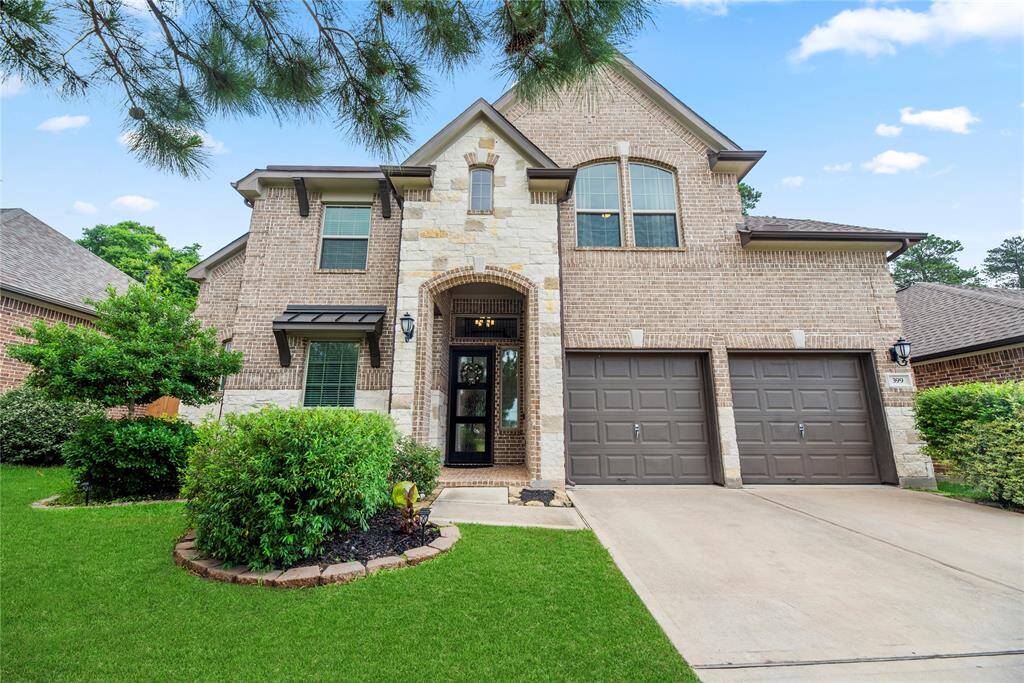 Inviting Curb Appeal: Striking brick and stone façade, beautifully landscaped entry, and a welcoming covered front porch set the tone for this stunning home.