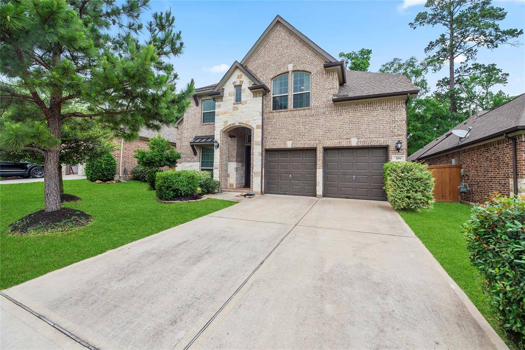 Expanded Driveway View: Extra-wide driveway provides ample parking for guests, framed by manicured landscaping and mature shade trees.