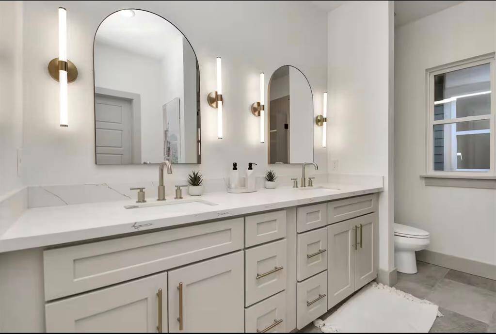 Primary Bathroom - complete with dual vanity, great lighting, & plenty of space for getting ready.