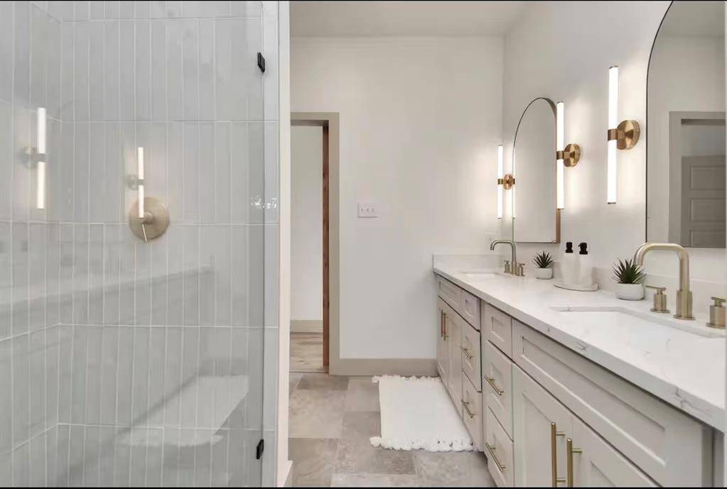 Primary bathroom - complete with the dual vanity and ample countertop and storage space.