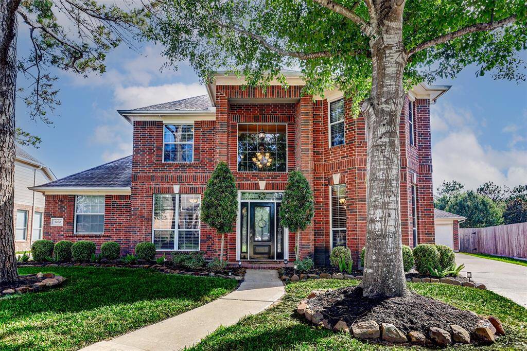 Lush landscaping makes you feel welcomed as you walk up to the front porch.
