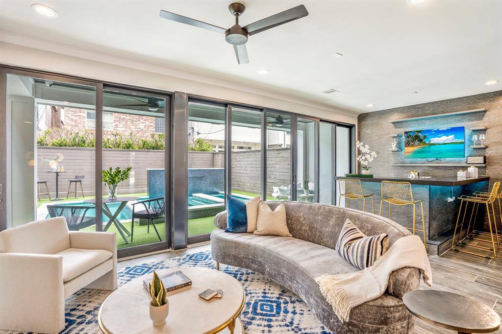 Open floor plan with new sliding glass door and custom bar over looking backyard