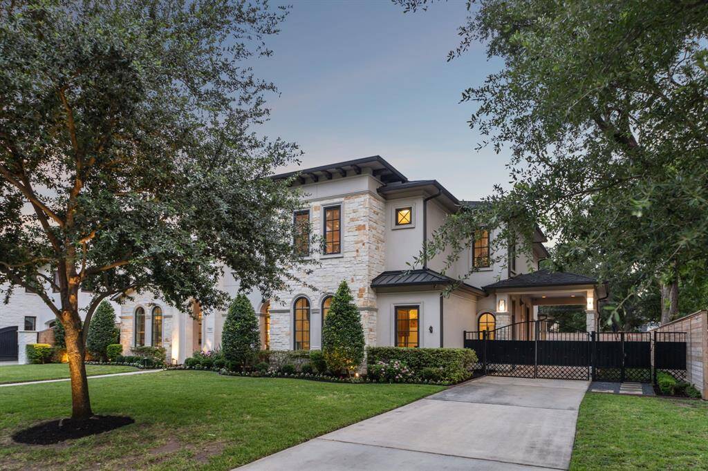 View of gated long driveway which provides secure access to the property. Porte-cochère and 3-car garage allow for ample storage and parking space.