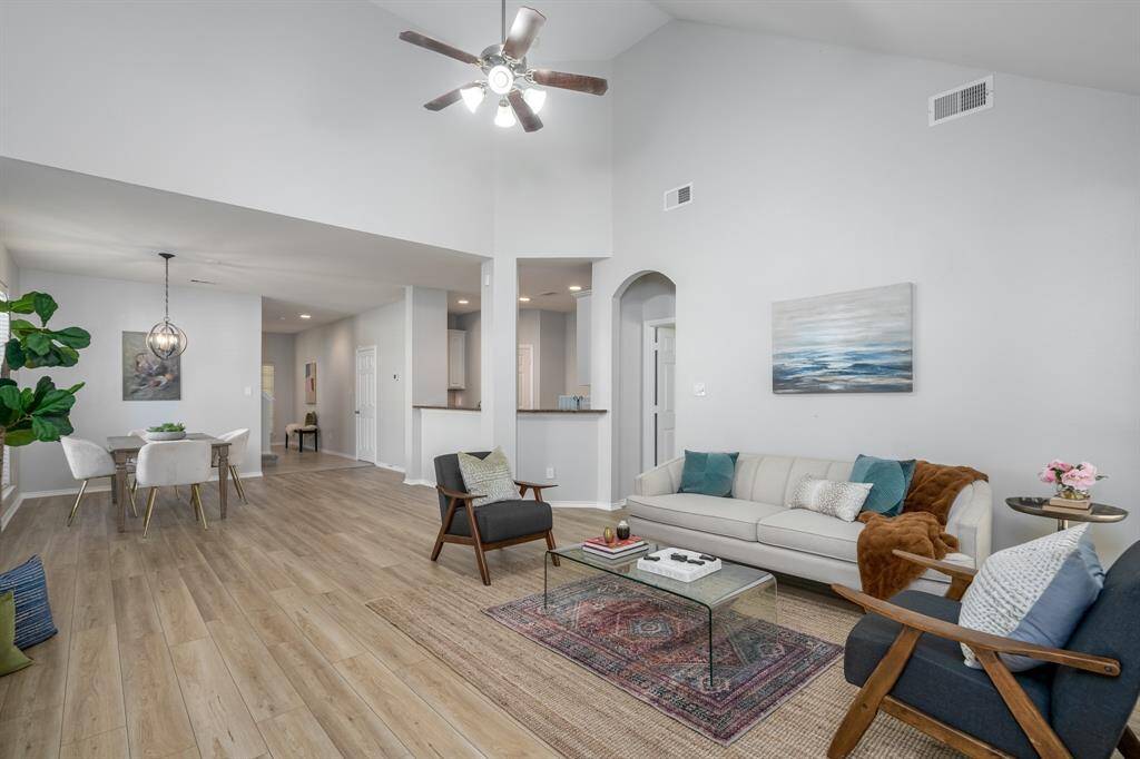 A cathedral ceiling and an abundance of natural lighting create a comfortable living area.