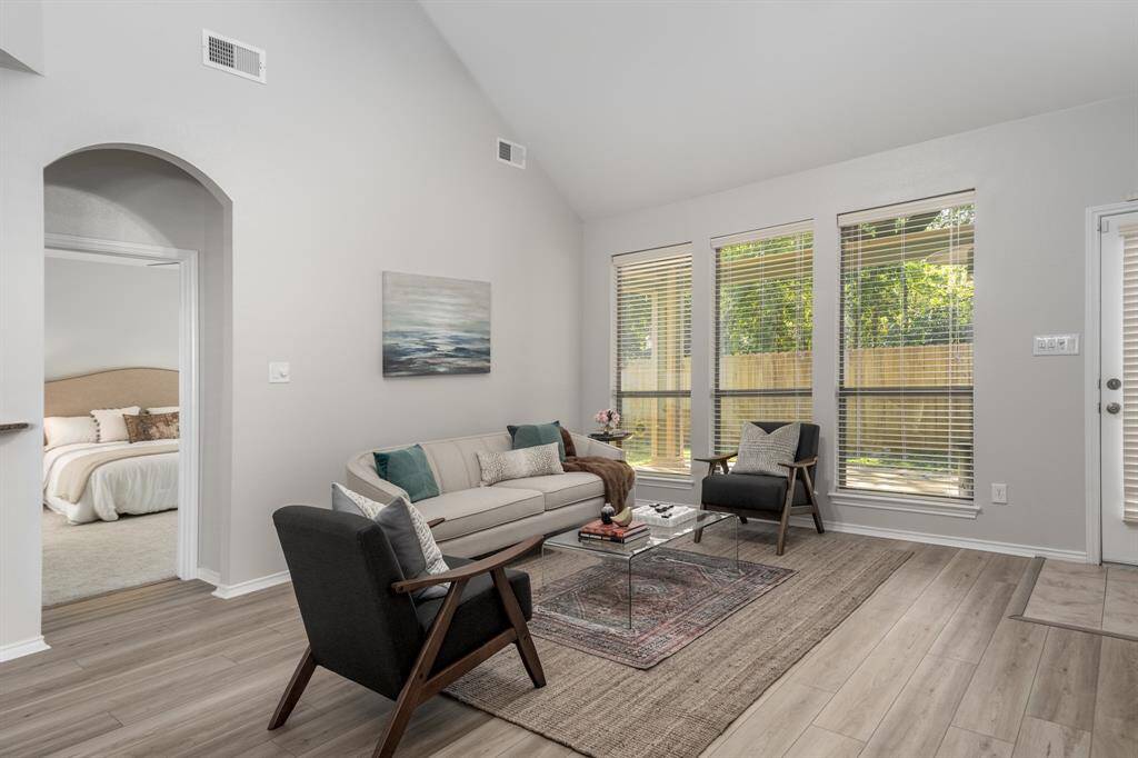 The family room looks out to the backyard. Notice the entry to the primary bedroom behind it.