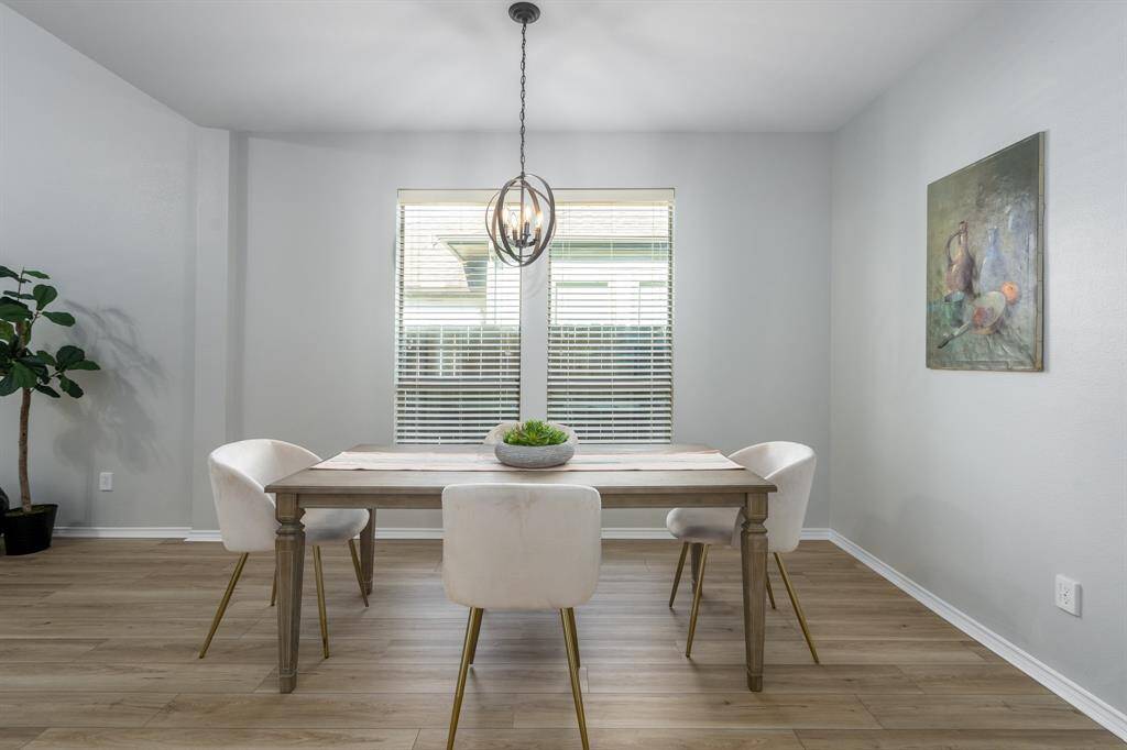 This lovely dining room is accented by exquisite drop lighting.