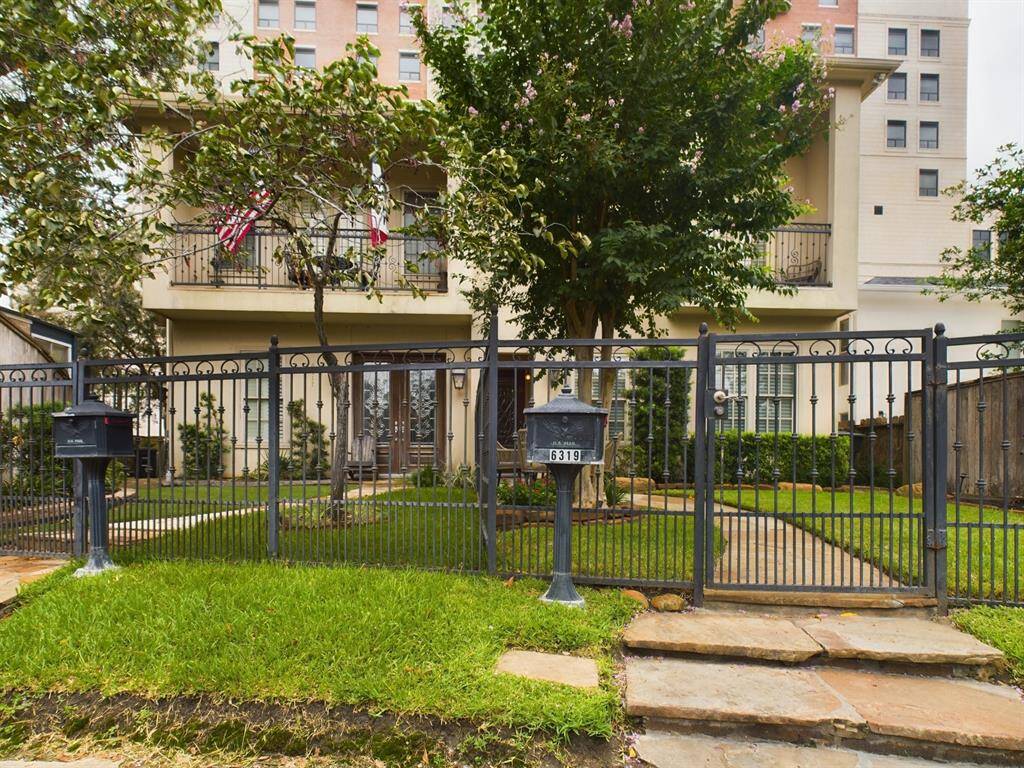 Fully fenced front yard with green space