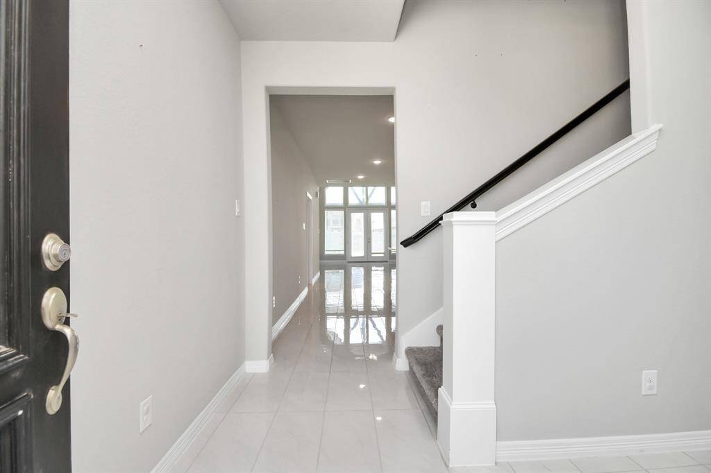 Step through the front door and you are greeted by a light and bright entryway with an abundance of natural light