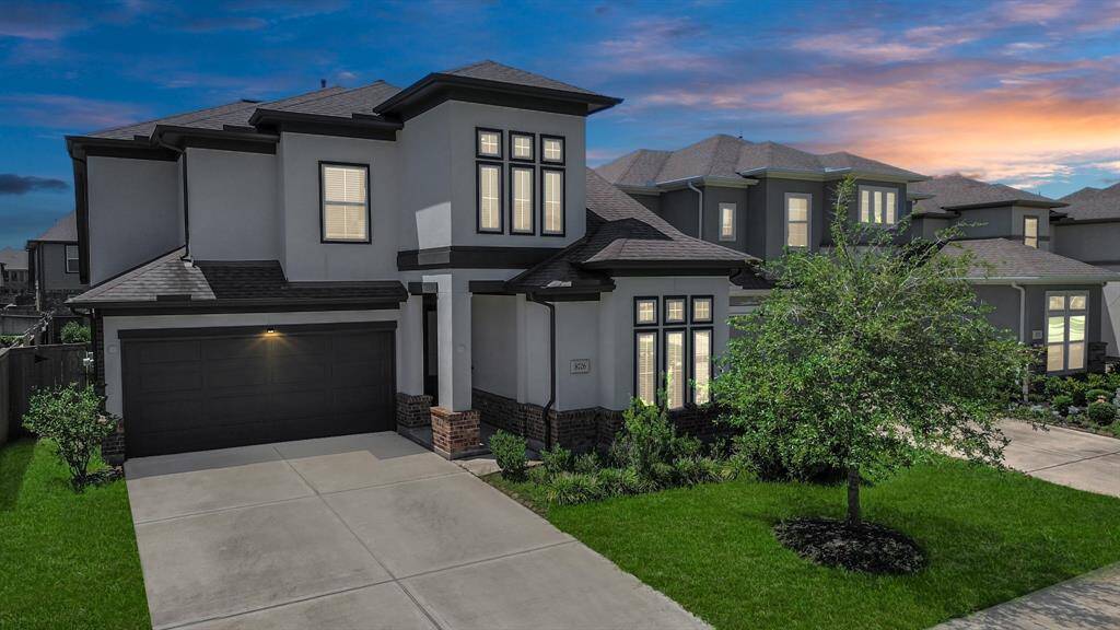 The twilight setting showcases the home's elegance and curb appeal