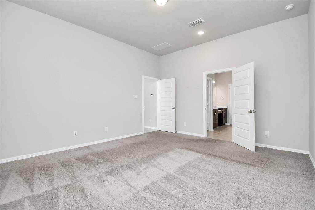 The inviting Primary Bedroom space offers a perfect blend of comfort and style ...