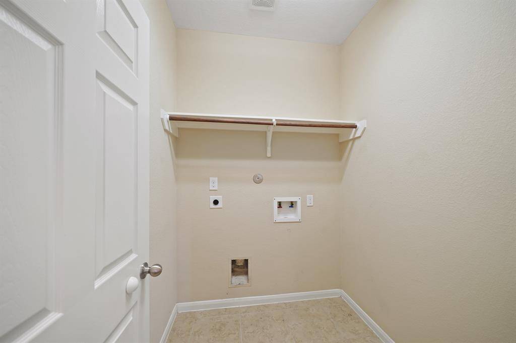 Utility room inside home next to garage entry