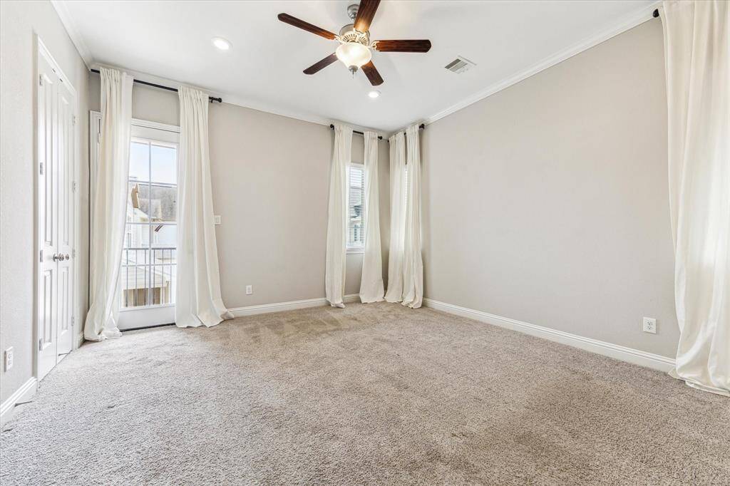 This spacious primary bedroom offers high ceilings, benefits from great light and has access to its own private balcony.  The en-suite bath is through the double doors on the left.