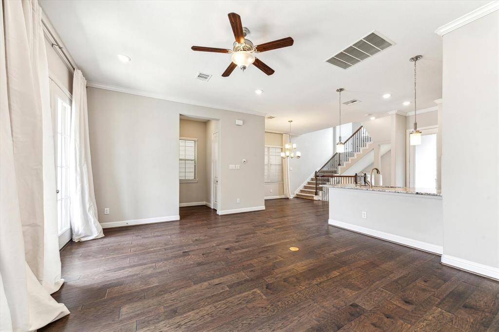 Tucked away in the small hallway straight ahead is a convenient powder bath and storage closet.