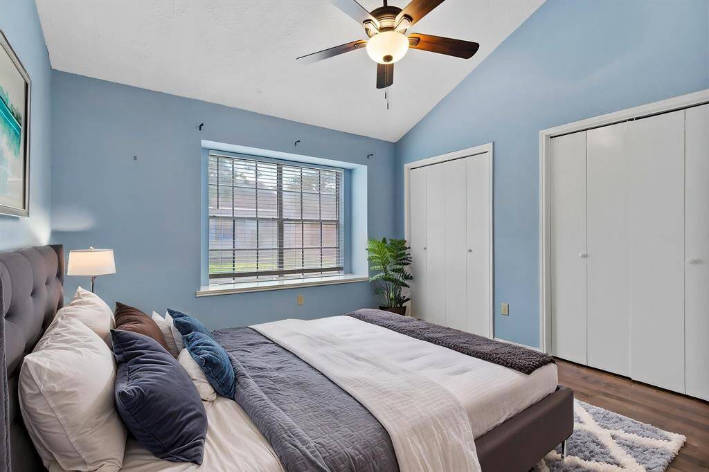 Step into the secondary bedroom, featuring gorgeous wood-look flooring, custom paint, and a large window that fills the room with just the right amount of natural light.