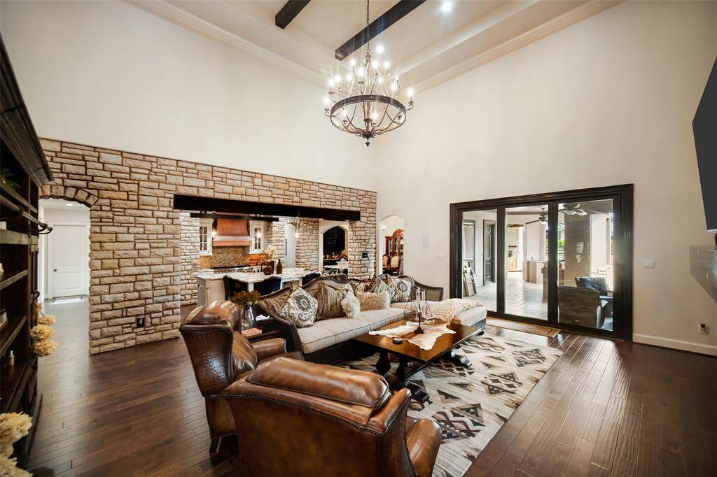 A view from the living room. The high ceilings are appointed with wooden beams and California doors for seamless indoor/outdoor living.
