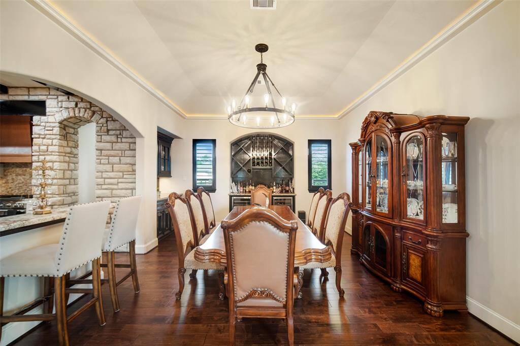 Dining room that opens to the kitchen. Notice  the back wall complete with wine storage and refrigerator.
