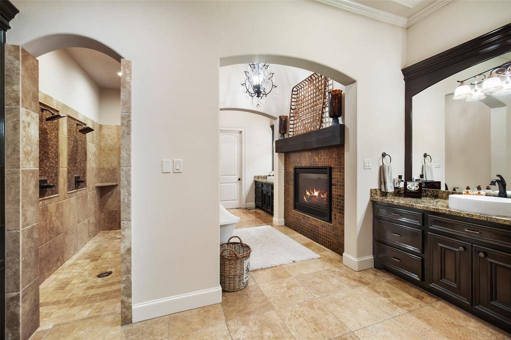Primary suite bathroom is  thoughtful  with separate sink and vanity areas.  A fireplace, soaking tub, dual showers and dual closets.