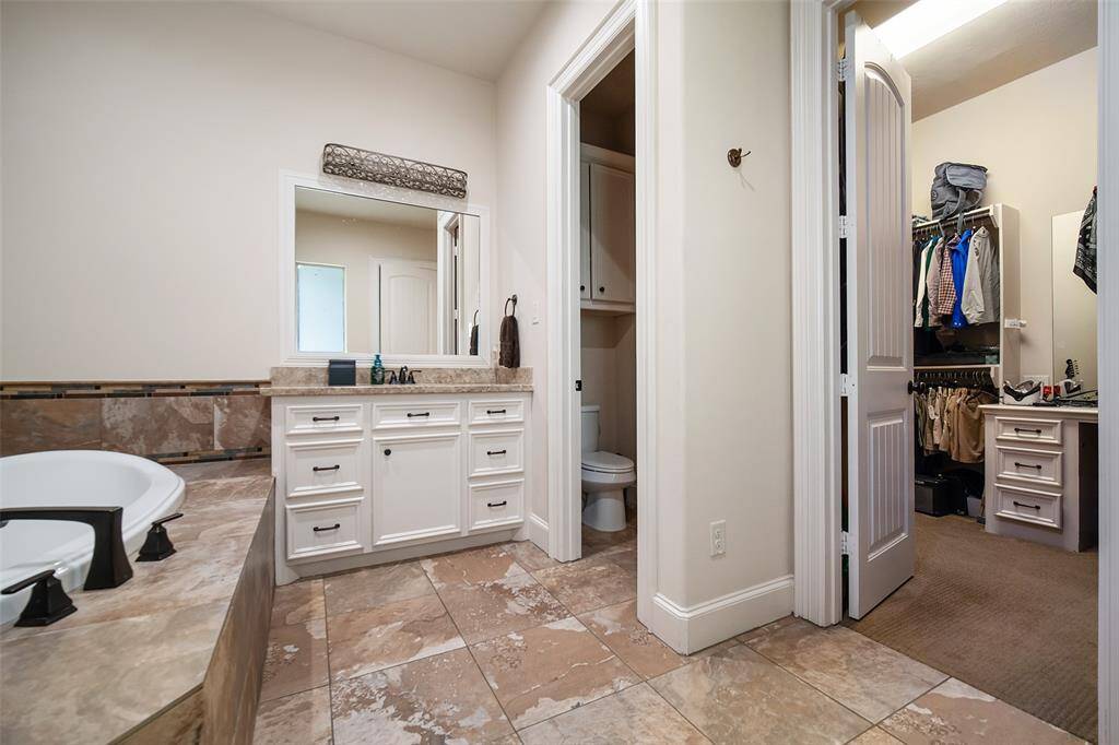 En-suite bath to second primary. Separate shower and tub and large closet with built in desk.