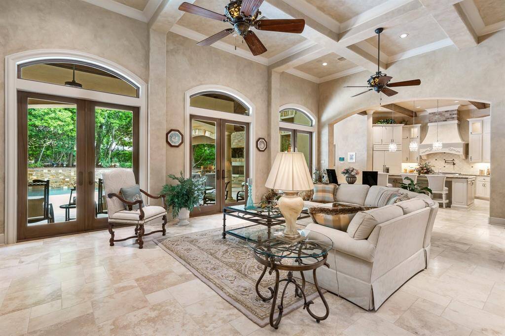 A trio of French doors not only frame picturesque views but also adds architectural charm and refined detail to the space.