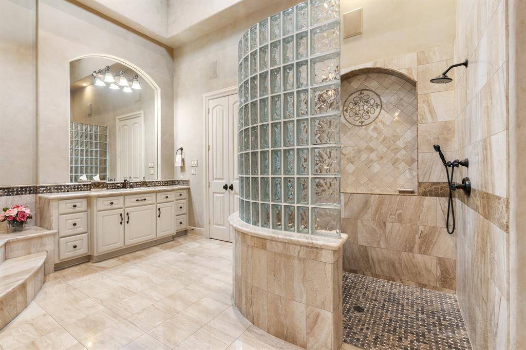 Timeless flooring, high ceiling with transom windows that provide plenty of natural light and his and her closets are additional highlights.