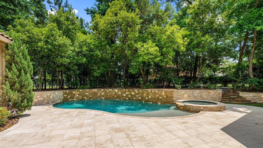 The beautifully landscaped backyard offers a peaceful retreat, enhanced by a built-in mosquito system for comfortable outdoor living year-round.
