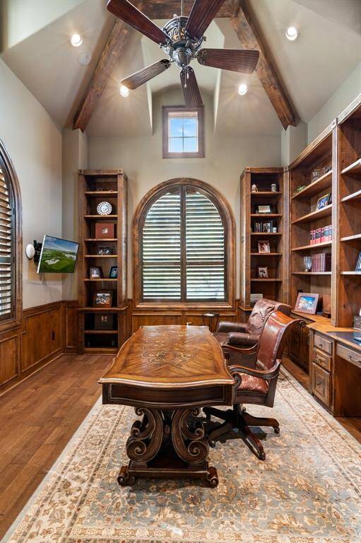 This space features a soaring ceiling accented by wood beams, rich Knotty Alder flooring and built-ins.