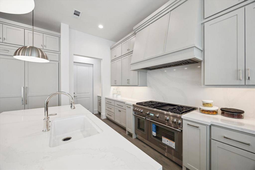 Kitchen features custom Benedettini cabinetry throughout.