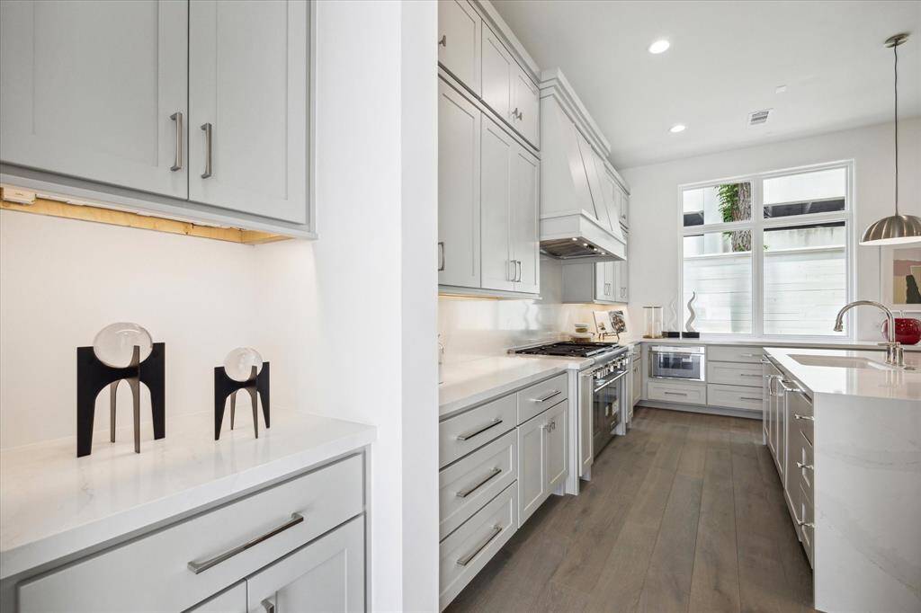 This drop zone can be found between garage and kitchen. With hooks, a bench, and storage cabinet, this space functions perfectly as a transition space.