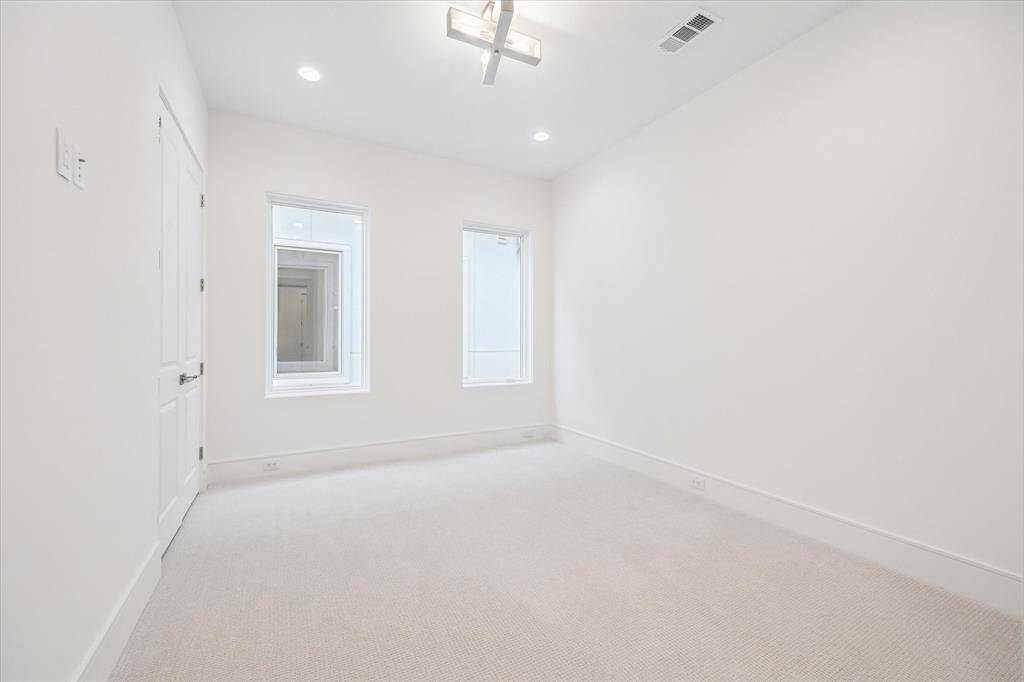 The first second-floor bedroom features Shaw high-performance carpet from their Aerial Collection and Progress Lighting brushed nickel light fixture with spacious closet.
