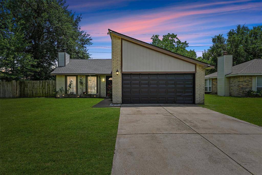 This inviting home stands proud at golden hour, where the soft sunset sky meets a beautifully maintained exterior. The original light-toned brick brings a timeless, earthy feel, perfectly balanced by the freshly painted dark garage door and trim. The contrast is clean and striking—elevating curb appeal without erasing the home’s original character. The warm porch light and natural landscaping pull it all together, creating a peaceful, grounded welcome.