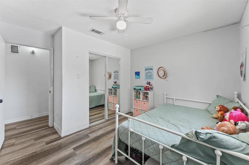 This secondary bedroom features mirrored closet doors, durable flooring, and plenty of room to personalize—whether for rest, play, or productivity.