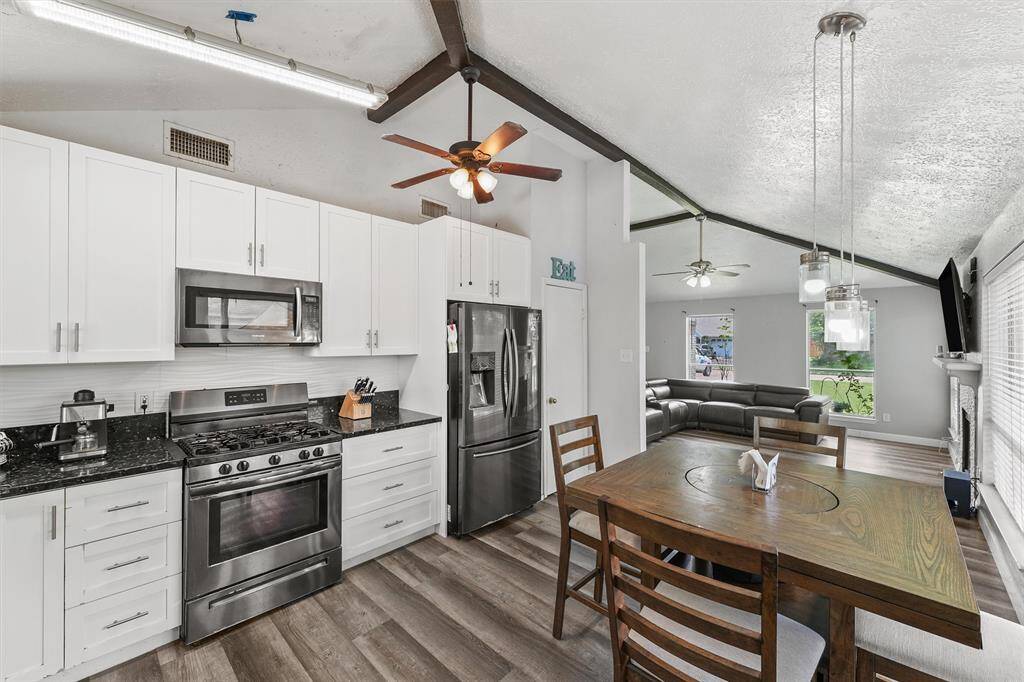 Crisp white cabinets, granite counters, and stainless steel appliances make this kitchen shine—while the open layout keeps you connected to the heart of the home.