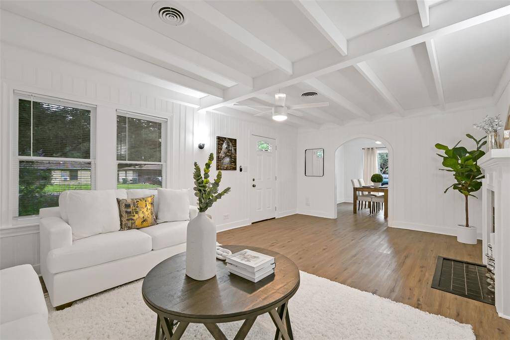 living room view towards dining room with arched entrance