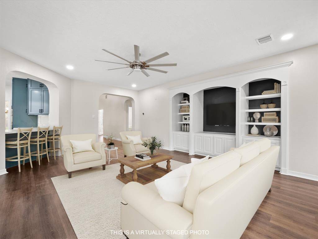 Custom built-ins in your living area & ceiling fans throughout! *This is a virtually staged photo
