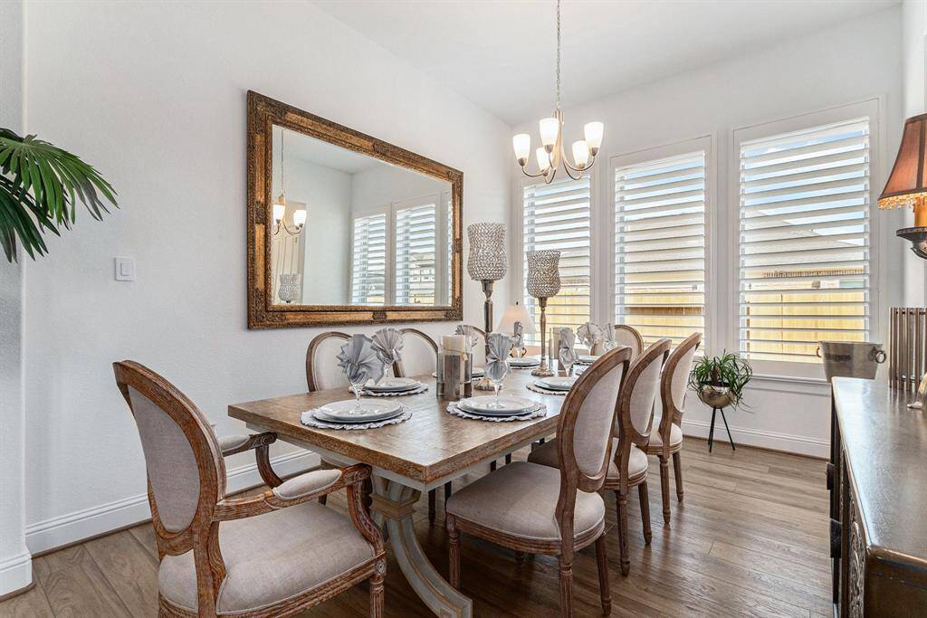 Elegant dining room featuring abundant natural light, chic furnishings, and a welcoming atmosphere for gatherings.