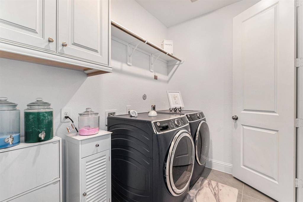 This efficient utility room features modern appliances and a sleek design, perfect for all your laundry needs.