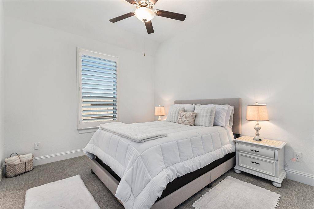Cozy secondary bedroom with ample natural light and modern finishes, perfect for guests with en suite.