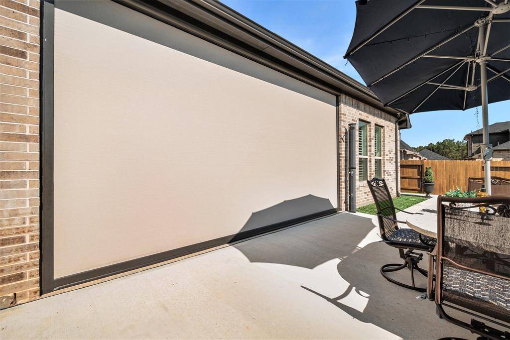 Inviting backyard patio with privacy and sun screen. Perfect for outdoor entertaining or relaxing in style.