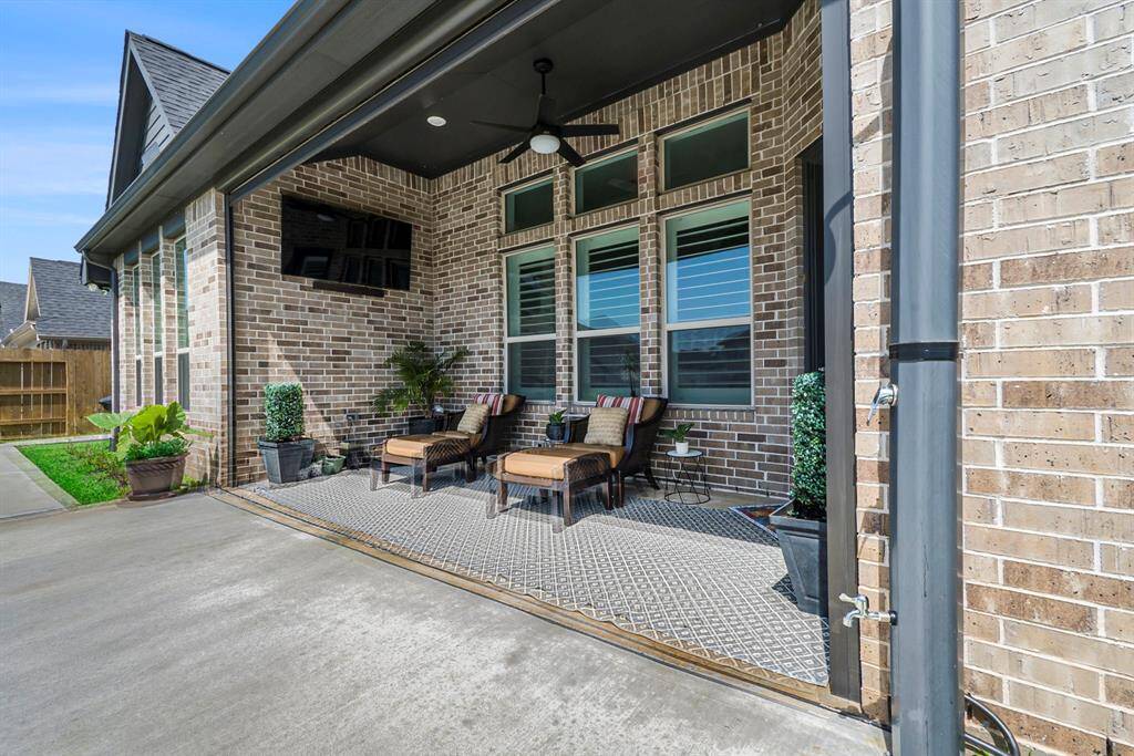 Charming backyard patio perfect for relaxing and entertaining, featuring cozy seating.