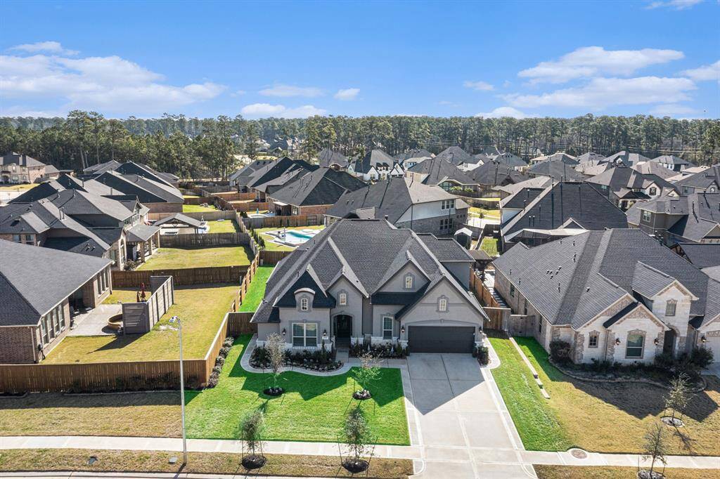 Charming 1.5-story home with a generous driveway and a two-car garage.