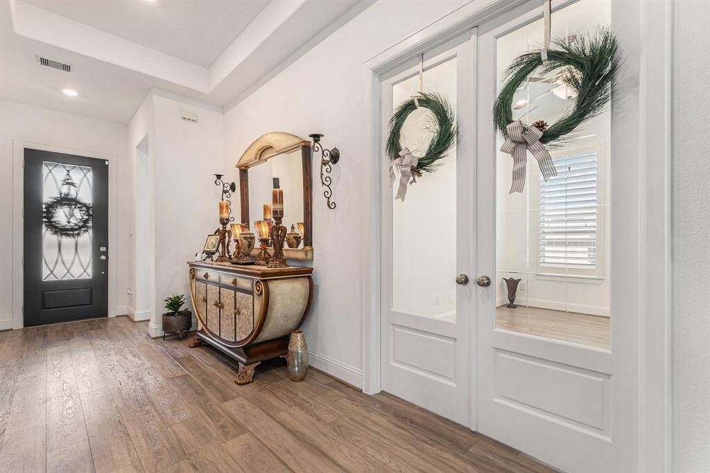 Stylish home office entry with elegant double doors and abundant natural light.