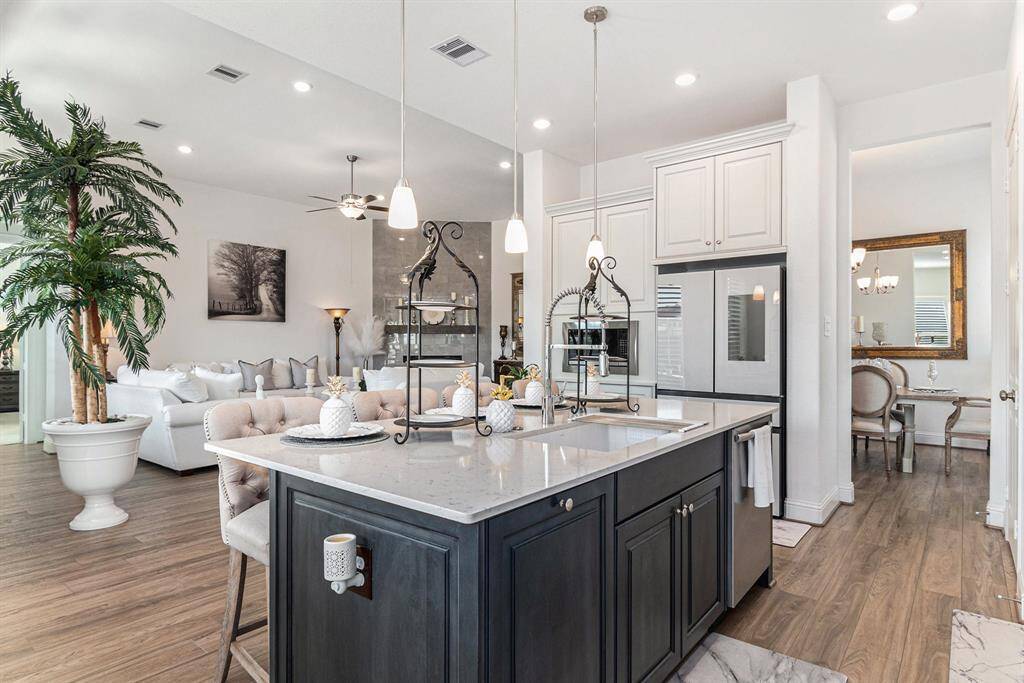 This modern kitchen features elegant countertops, sleek cabinetry, and an inviting open layout, perfect for both cooking and entertaining.