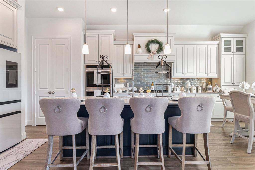 Spacious island with stylish seating, sleek modern appliances, and ample cabinet space for all your culinary needs. Perfect for both entertaining and everyday living.