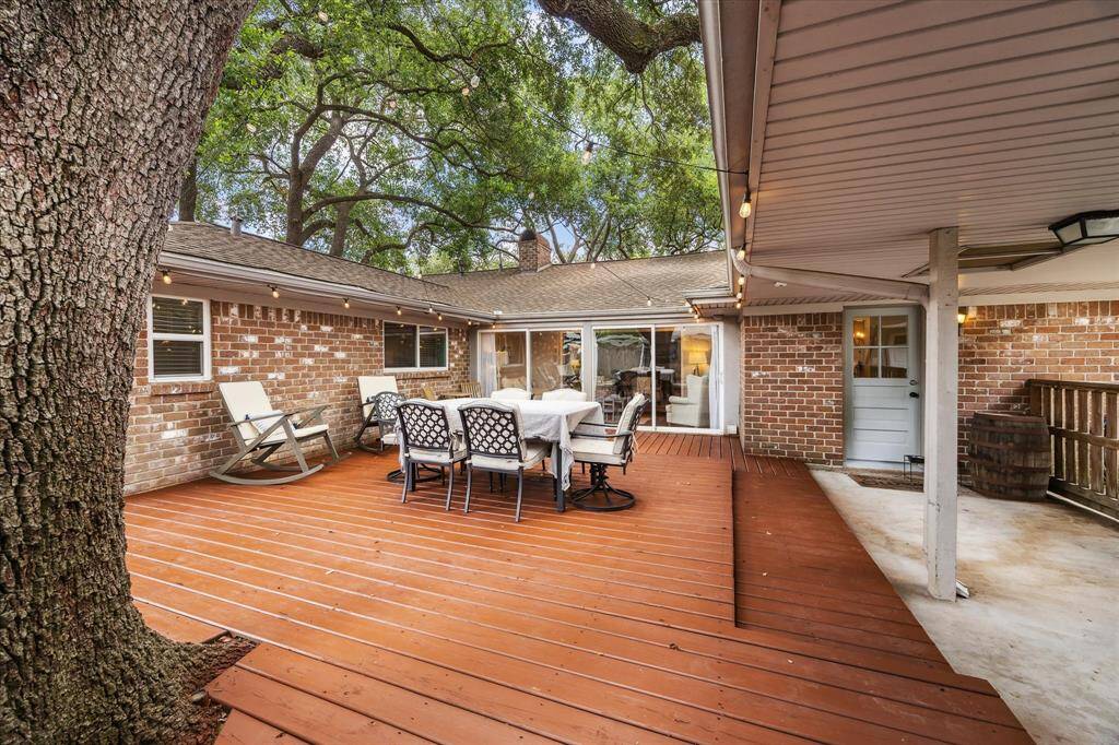 This inviting photo showcases the spacious backyard patio with a wooden deck, perfect for outdoor entertaining.