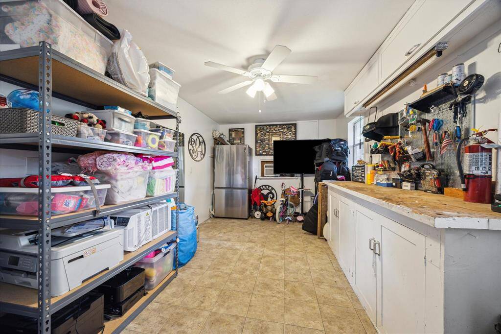 A versatile extra room with ample storage and AC. The space is practical for hobbies, additional storage, a gym, or extra office.