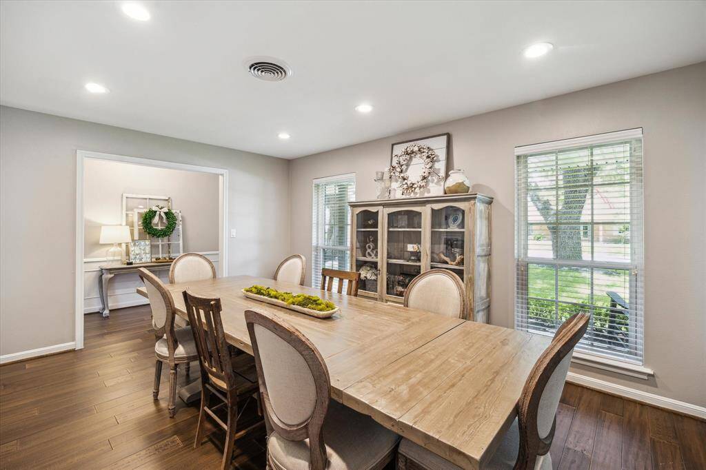 The dining room features large windows providing ample light creating a warm and inviting atmosphere.